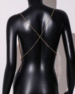 Close-up of the cross-back design on a gold sequin metal crop top for women