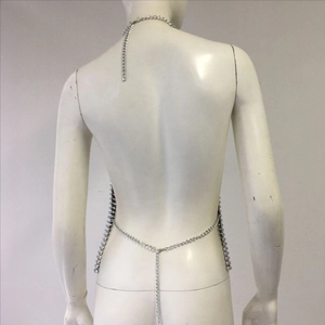 Detail of silver metal body chain featuring cross-back design and sparkling rhinestones