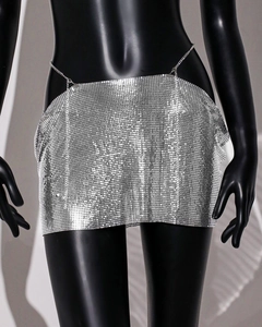Detail of silver metallic sequin mesh mini skirt with fine chain link and reflective finish