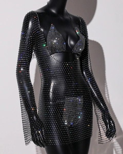 Close-up of black mesh fishnet dress featuring sparkling rhinestones and long sleeves