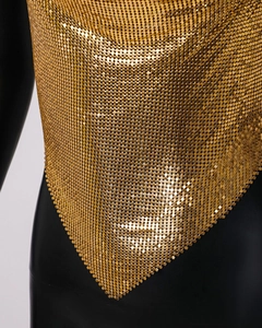 Close-up of golden metallic sequin halter top featuring reflective mesh texture for festivals