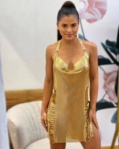 Close-up of golden metallic sequin dress with cowl neck and halter back for party wear