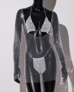 Close-up of sparkling rhinestone fishnet dress with glitter details and long sleeves