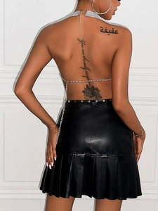 Sexy backless silver rhinestone halter top paired with a black pleated leather skirt