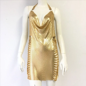 Macro shot of gold metal mesh sequins and chain weave texture on halter dress