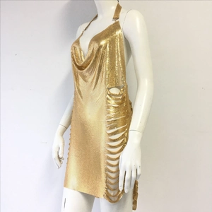 Detail of gold chainmail dress showing side cut-outs and metallic mesh texture