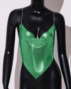 Detailed macro view of the green metallic mesh texture and sequin fabric on the halter top