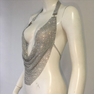 Detail of silver rhinestone halter top with glittering metal chains for party wear
