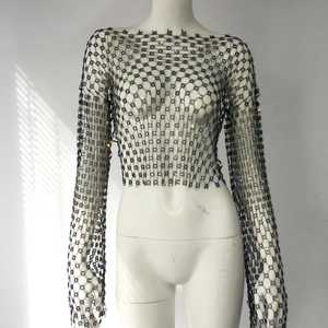 Close-up of black mesh crop top with shimmering colorful rhinestones for party wear