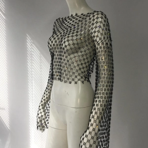 Detail of sheer black mesh top with shimmering rhinestones and long sleeves for party
