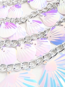 Close-up of metallic chain links with iridescent shell pendants featuring laser texture