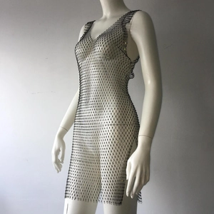 Close-up of black mesh mini dress with shimmering rhinestones and sexy side slit detail