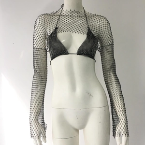 Detail of black rhinestone fishnet two-piece set with halter top and long sleeve mesh shrug