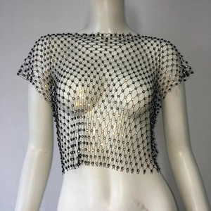 Detailed macro view of black fishnet mesh fabric with sparkling round crystal rhinestones