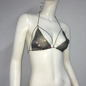 Detailed close-up of sexy black fishnet bikini top with sparkly colorful rhinestones