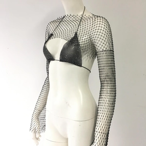 Close-up of black rhinestone fishnet crop top and matching bikini set detail