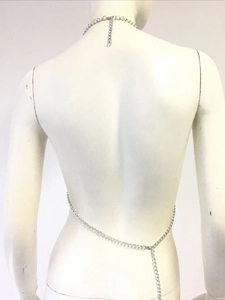Silver sequin halter body chain with cross back design on white mannequin for beachwear