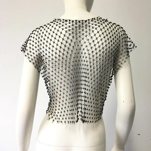 Close-up detail of black mesh crop top featuring sparkling rhinestones on fishnet structure