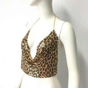 Macro detail of leopard print metallic sequins and gold chain neck strap on vest