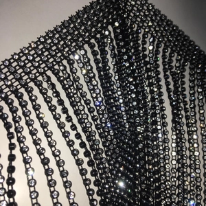 Macro detail of high-quality black mesh fabric with sparkling rhinestones for party tops