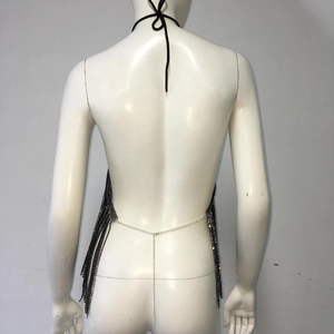 Detail showing the adjustable silver metal chain and rhinestone fringe on a black halter top