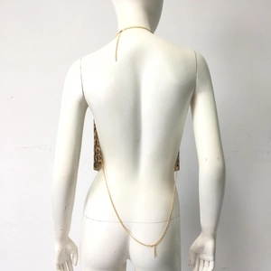 Detail of metal sequin backless top showing chain straps and leopard pattern texture