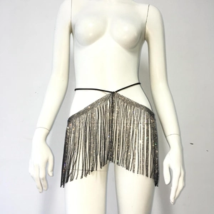 Detailed macro view of sparkling rhinestone fringe body chain and black waist strap