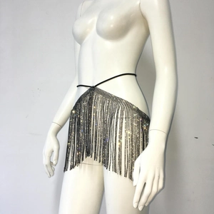 Detail of sparkling rhinestone fringe body chain and black waist strap on mannequin