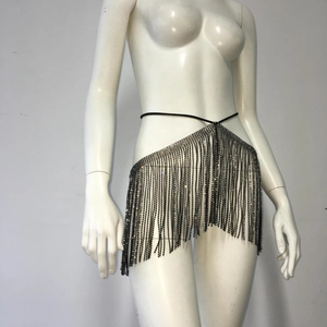 Detail view of shimmering rhinestone fringe tassels with a black tie-up waist belt