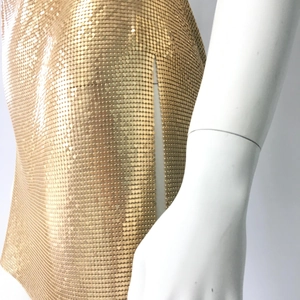 Detail of gold metal mesh sequins showing the shimmering chainmail texture and craftsmanship
