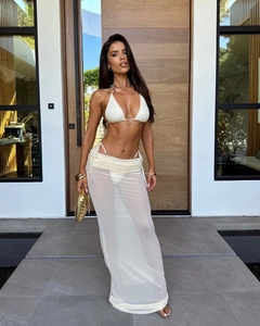 Detailed look at white bikini set with metallic rings and matching sheer mesh maxi skirt