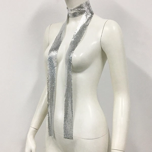 Detail of silver metallic mesh sequin scarf with shiny reflective texture on a mannequin