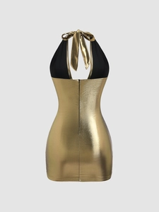 Close-up of halter back with metallic gold fabric and black bow tie detail