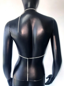Detailed back view of silver metal body chain with cross-chain design on a black mannequin