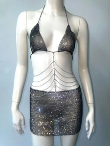 Detail view of sparkly black mesh party dress with metallic chains and sequins