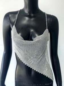 Macro detail of silver metallic mesh sequins and chain strap on asymmetrical top