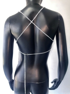 Macro detail of the silver metal chain body chain showing the X-shaped cross back design