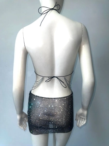 Close-up of a sexy black mesh mini skirt with high-density rhinestones and cross straps