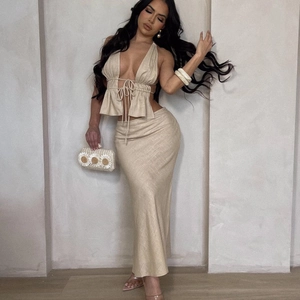 Detail of the high-waisted beige skirt and textured linen-like fabric on the two-piece set