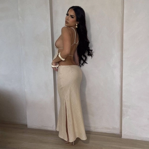 Close-up of beige tie-up backless top and high-slit long skirt with textured fabric