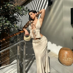 Detail of beige two-piece halter set showing drawstring V-neck and soft pleated fabric