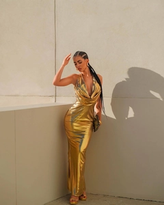 Detailed view of the gold metallic backless halter neck dress with mermaid cut design