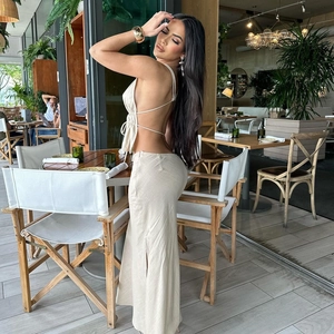 Detail of beige backless halter top and high-waist side slit skirt in linen texture