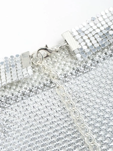 Detailed shot of shiny silver metal mesh fabric with lobster clasp and extension chain