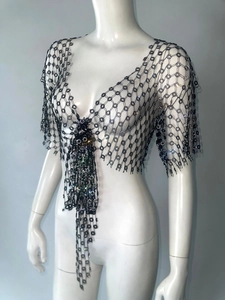 Detail of black floral sequin mesh bolero jacket with fringe tassel ties for music festivals