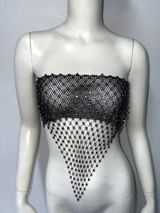 Detail of sexy black fishnet tube top featuring sparkling rhinestones and a pointed hem