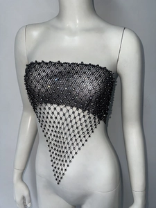 Close-up of sexy black mesh crop top with shimmering rhinestones and tassel hem detail