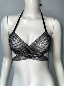 Close-up of the intricate rhinestone mesh detailing and cross-strap tie design on the vest