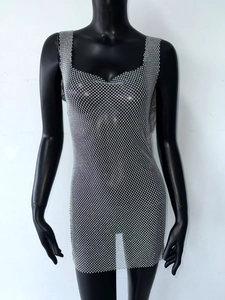 Detailed close-up of sparkling silver rhinestones on a sheer mesh party dress