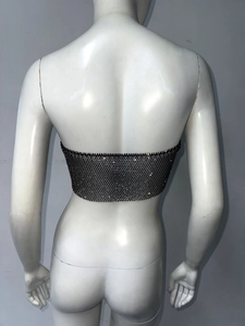 Macro view of sexy black fishnet tube top with high density rhinestones and metal mesh